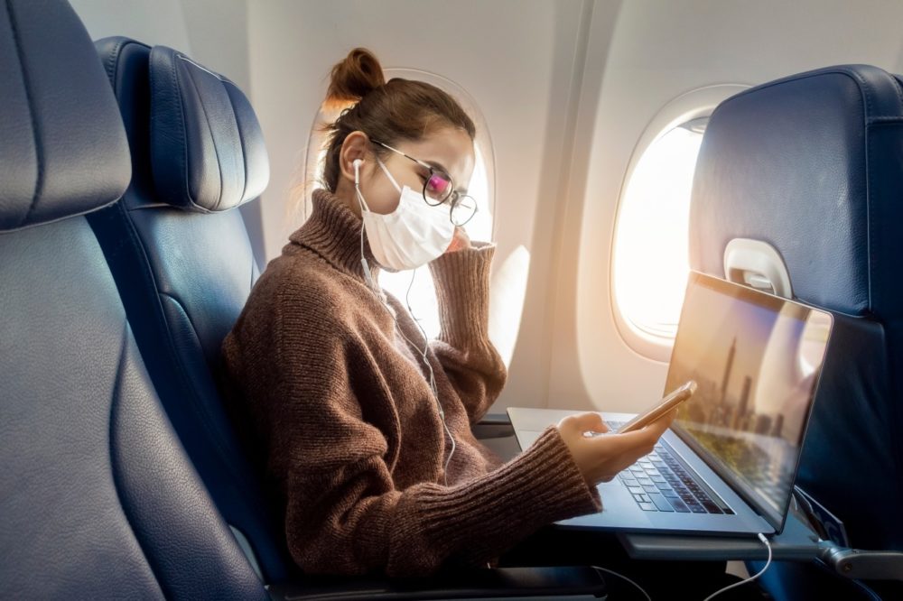 William-Russell-Blog-What-You-Need-to-Know-About-COVID-19-and-Insurance-covid-flight-in-face-mask
